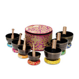 Sanskar Nepal - Tibetan Singing Bowl Set of 7, Handcrafted Singing Bowl for Meditation & Holistic Healing, Yoga Accessories, 3-5” Black Singing Bowls with Wooden Striker, Cushion & Purple Carry Box